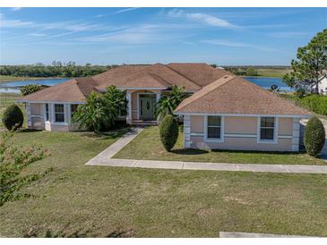 Charming single-story home with a well-manicured lawn and beautiful landscaping at 2656 S Scenic Hwy, Lake Wales, FL 33898