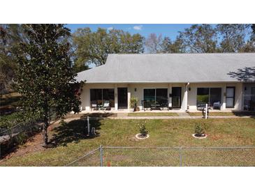 Charming single-story villa with a well-maintained lawn and cozy outdoor seating areas at 711 Springer Dr # 9, Lake Wales, FL 33853