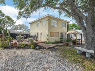 Lovely home featuring a spacious backyard with deck, seating and mature landscaping at 1351 Smokey Rd, Lake Wales, FL 33859