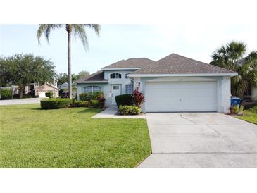 Charming single-Gathering home with a well-manicured lawn, a two-car garage, and lovely landscaping at 2200 Mallory Cir, Haines City, FL 33844