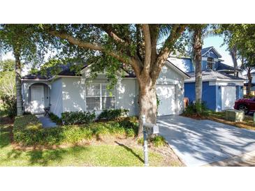 Charming single-story home with well-maintained lawn and mature trees providing shade and curb appeal at 2696 Hemingway Ave, Haines City, FL 33844