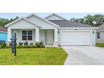 Charming single-Gathering home with a well-manicured lawn and a two-car garage at 4545 Fairway Oaks Dr, Mulberry, FL 33860
