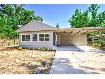Charming single-story home featuring a carport, neutral paint, and landscaping with sunny curb appeal at 318 Senate St, Auburndale, FL 33823