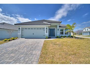 Charming single-story home with a paver driveway, attached two-car garage and a well-maintained lawn at 4687 Grandview Glen Dr, Auburndale, FL 33823