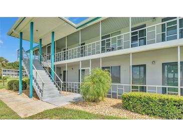 Bright condo building with blue accents and well-maintained landscaping at 1600 W Lake Parker Dr # A2, Lakeland, FL 33805