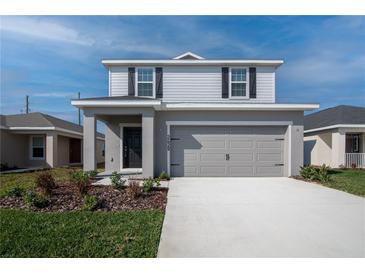 Charming two-story home with a two-car garage and well-maintained landscaping at 2429 Leeds St, Haines City, FL 33844