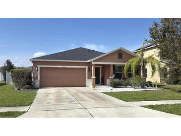 Charming single Gathering home with neutral tones, well maintained lawn, and an attached two-car garage at 1109 Brenton Manor Dr, Winter Haven, FL 33881