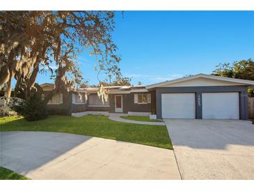 Charming single Gathering home with a well-manicured lawn, mature trees and a two car garage at 1865 15Th Nw Ct, Winter Haven, FL 33881