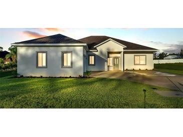 Charming single-story home featuring a well-manicured lawn and a welcoming front entrance at 570 Gandhi Dr, Lakeland, FL 33813