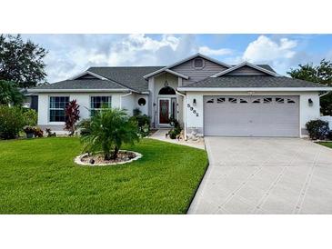Charming single-story home with well-manicured lawn, landscaping, and a two-car garage at 5982 Crane Dr, Lakeland, FL 33809