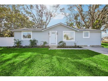 Charming single-story home with a well-manicured lawn and inviting front entrance at 5225 Golden Gate Blvd, Polk City, FL 33868