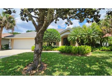 Charming single-story home with lush landscaping, mature trees, and a well-maintained lawn at 108 Lake Region N Blvd, Winter Haven, FL 33881