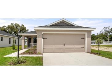 Charming one-story home with a two-car garage and well-maintained landscaping at 572 Sw 77Th Cir, Ocala, FL 34480