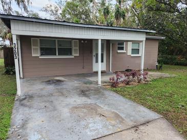 Charming single-story home with a covered front porch and a cozy, well-maintained yard at 3203 Decatur Ave, Lakeland, FL 33805