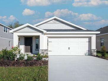 Charming single-story home with a two-car garage and well-maintained landscaping at 3166 Laurel Oak Ln, Winter Haven, FL 33884