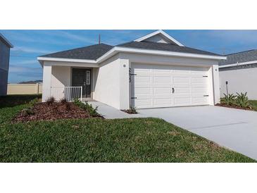 Charming single-story home with attached garage and well-maintained lawn at 2433 Leeds St, Haines City, FL 33844