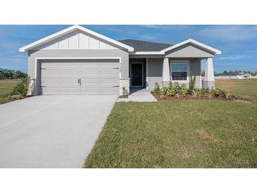Charming single-Gathering home featuring a two-car garage and neatly manicured lawn at 720 Bayside Blvd, Winter Haven, FL 33881