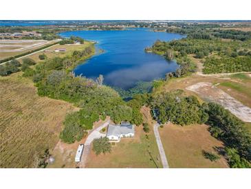 Stunning aerial view of a charming property with a serene lake as its backdrop at 309 W Frederick Ave, Dundee, FL 33838