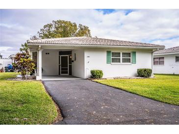 White single story home with carport and green landscaping at 561 Cameo Dr, Lakeland, FL 33803
