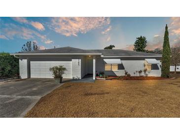 White single-story house with a two-car garage and well-maintained lawn at 3107 Valley High Dr, Lakeland, FL 33813