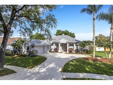 Stunning curb appeal, with circular driveway and lush landscaping at 5933 Lake Victoria Dr, Lakeland, FL 33813