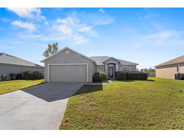 Single-story house with attached garage and a spacious lawn at 8183 Westmont Terrace Dr, Lakeland, FL 33810
