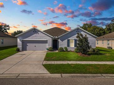 Curb appeal abounds in this charming one-story home, featuring a two-car garage and well-manicured lawn at 1655 Laurel Oaks Dr, Bartow, FL 33830