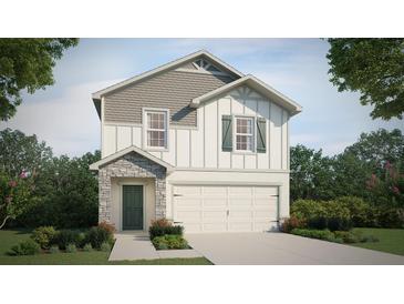 Two-story house with stone accents and a two-car garage at 2327 Northumberland Ct, Haines City, FL 33844