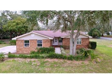Brick ranch house with large yard and mature trees at 7405 Havenwood Dr, Lakeland, FL 33810