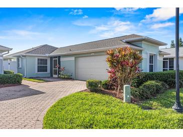 Single-story home with attached garage and landscaped front yard at 3441 Grenville Dr, Winter Haven, FL 33884