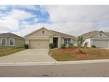 One-story house with a two-car garage and well-maintained landscaping at 433 Montego Bay Dr, Mulberry, FL 33860