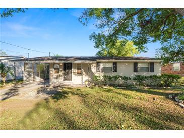Tan house with carport, landscaping, and a spacious yard at 514 Mohawk Ave, Lakeland, FL 33815