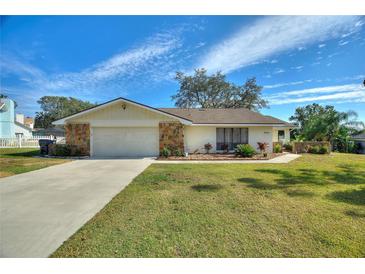 Single-story home with stone accents and landscaped yard at 6004 Greenleaf Cir, Winter Haven, FL 33884
