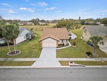 Single-story house with a two-car garage and a well-maintained lawn at 4032 Derby Dr, Lakeland, FL 33809