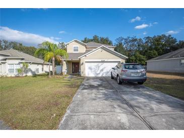 Two-story house with a driveway and landscaping at 8309 Porch Ct, Lakeland, FL 33810