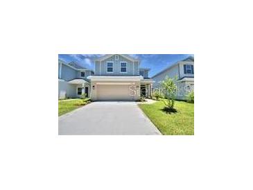 Two-story house with attached garage and front yard at 1505 Leamington Ln, Winter Haven, FL 33884