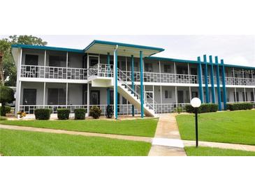 Building exterior showcasing mid-century modern architecture with a walkway and landscaping at 1600 W Lake Parker Dr # B7, Lakeland, FL 33805