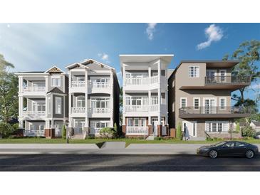 Charming exterior elevation showcasing three-story homes, manicured lawns, and inviting balconies under a bright blue sky at 23 Lake Hollingworth, Lakeland, FL 33803