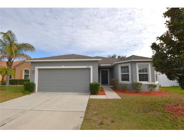 Single-story house with gray siding, two-car garage, and landscaped yard at 3648 Julius Estates Blvd, Winter Haven, FL 33881