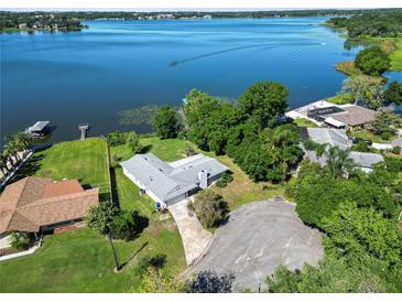 Aerial view of a single-story home on the lake, with a large backyard and boat access at 5252 Post Ln, Lakeland, FL 33809