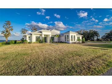 Luxury waterfront home with expansive lawn and modern design at 5272 Riverlake Dr, Bartow, FL 33830