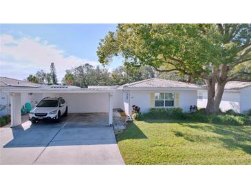 Front view of charming single story home with carport and mature landscaping at 646 Cottage Ln, Lakeland, FL 33803