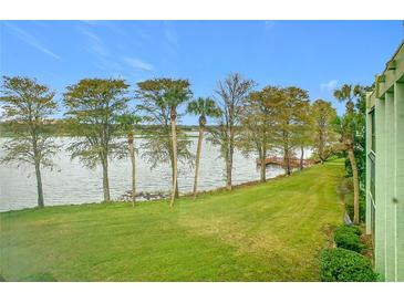 Scenic view of a lake with lush green grass and palm trees at 1130 N Lake Parker Ave # A302, Lakeland, FL 33805