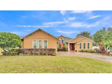 Beautiful one-story house with a landscaped lawn and brick driveway at 178 Magneta Loop, Auburndale, FL 33823