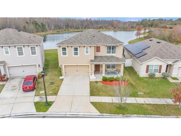 Two-story house with solar panels and lake view at 1915 Pristine Loop, Lakeland, FL 33811