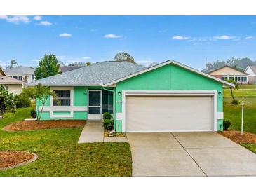 Cute teal house with a 1-car garage and well-maintained lawn at 2266 Silver Re Dr, Lakeland, FL 33810