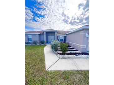 House exterior features a walkway and landscaping at 351 Cloverdale Rd, Winter Haven, FL 33884