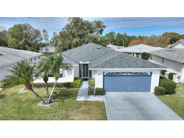 Single-story home with a gray roof, attached garage, and landscaped yard at 3618 Highland Fairways Blvd, Lakeland, FL 33810