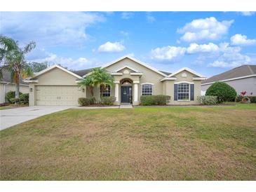 One-story home with attractive landscaping and a two-car garage at 4009 Oakley Way, Lakeland, FL 33813