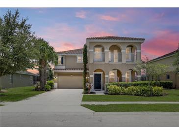 Two-story house with a landscaped yard and attached garage at 4179 Oaktree Dr, Davenport, FL 33837